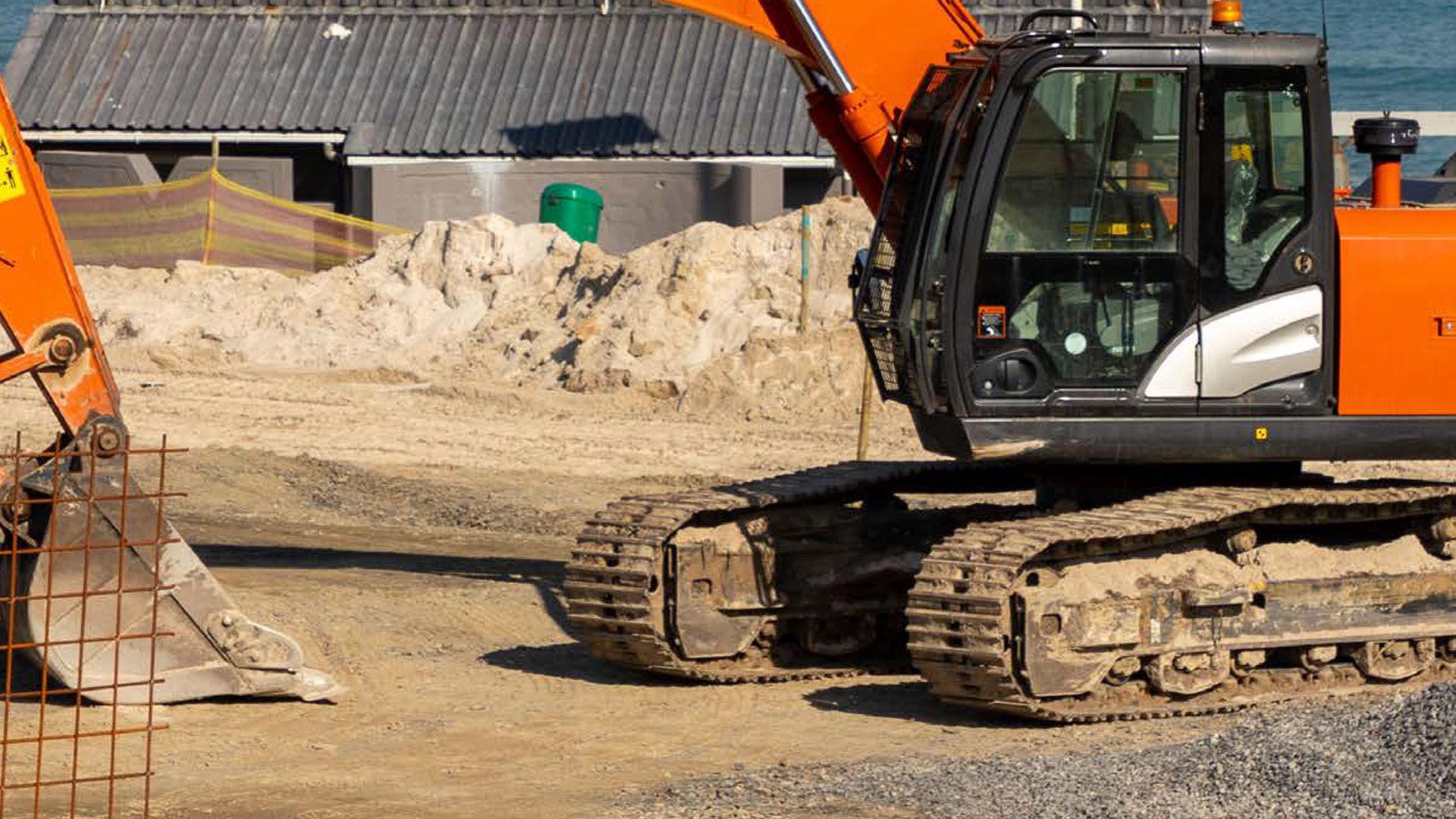 Orange crawler excavator on yard.