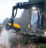 Black and yellow forestry harvester in action.